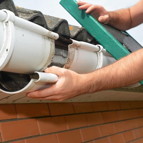 Roofing Guys Sydney carrying out gutter repairs on a tiled roof. We fix cracked, leaking, and rusted gutters with professional replacements and maintenance services.