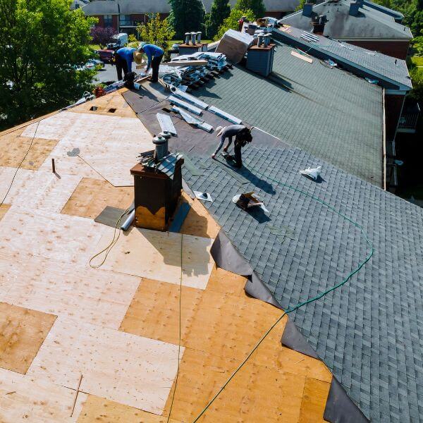 Roofing Guys Sydney team mid-way through a full roof repair and re-sheeting project in Sydney, replacing damaged structure and laying new shingles for long-term protection.