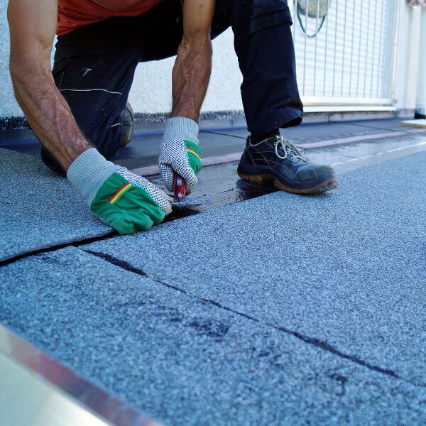 Roofing Guys Sydney technician performing urgent commercial roof repairs using bitumen membrane on a flat roof surface in Sydney Roofing Guys Sydney technician performing urgent commercial roof repairs using bitumen membrane on a flat roof surface in Sydney