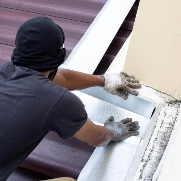 Roofing Guys Sydney technician repairing flashing during a residential roof maintenance job in Sydney.