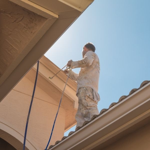 Roof painting in Sydney with a professional tradesman applying fresh coatings to restore and protect a tiled roof Roof painting in Sydney with a professional tradesman applying fresh coatings to restore and protect a tiled roof