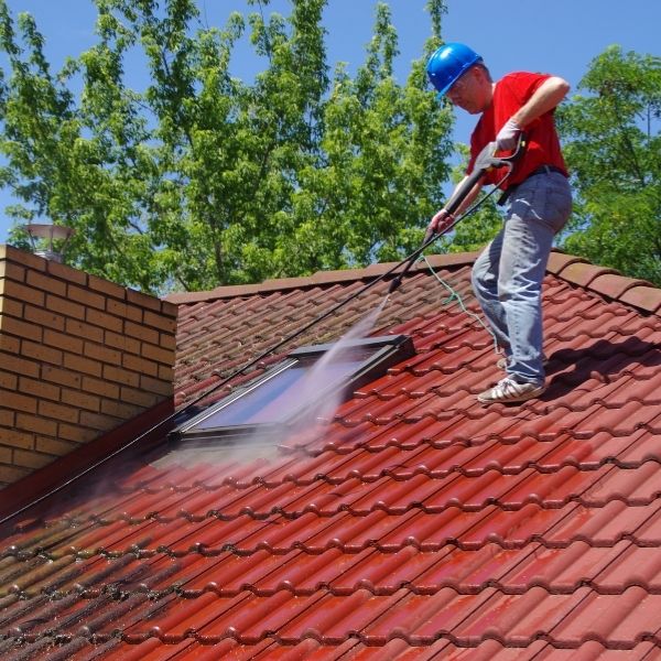 Professional roof cleaning Sydney by Roofing Guys Sydney removing moss and dirt with high-pressure washing