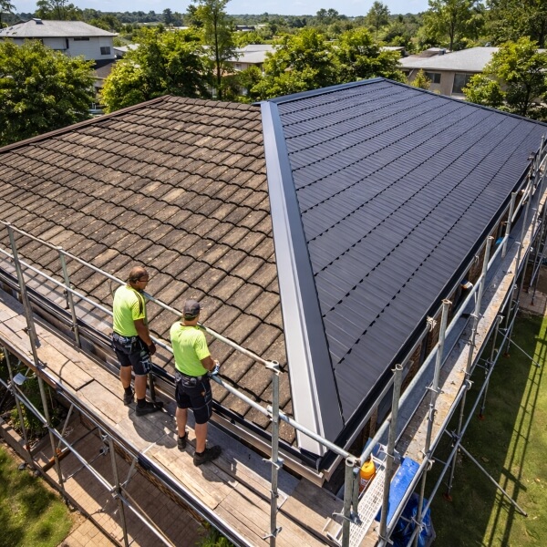 Tile to Colorbond roof conversion in Sydney by Roofing Guys, replacing old tiled roof with new Colorbond metal roofing.